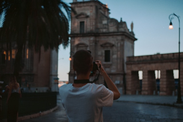 Person taking a photo of a white while traveling